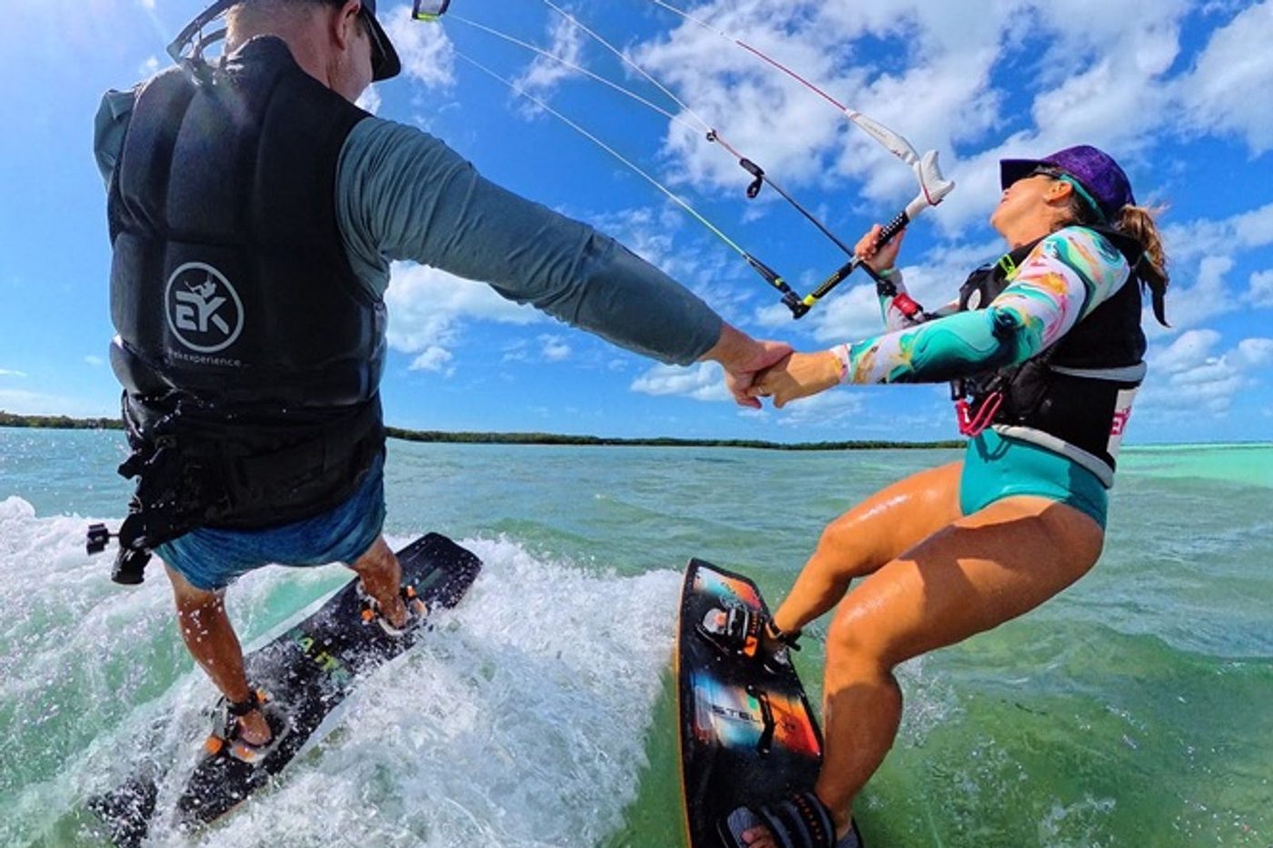 EK Experience instructor riding alongside a student, coaching hands-on in the water