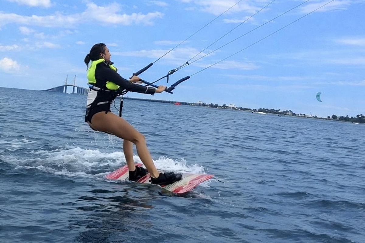 EK Experience instructor guiding a beginner student on the bar during a lesson